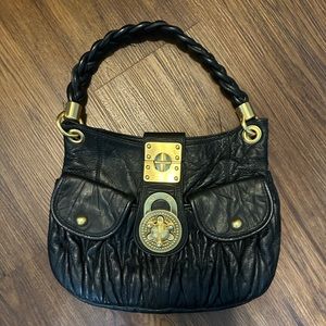 black leather purse with gold clasp. STEVEN by Steve Madden